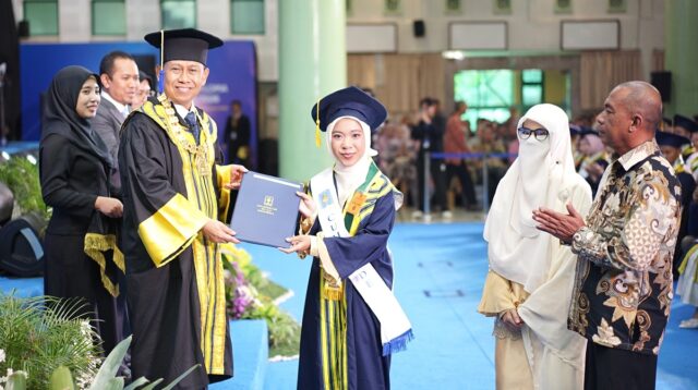 Prof Hari Purnomo menyerahkan ijazah dan Pin Emas kepada wisudawati terbaik yang disaksikan kedua orangtuanya. (foto : istimewa)