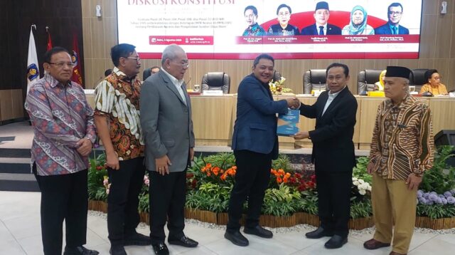 Taufik Basari (kiri) menyerahkan kenang-kenangan kepada Prof Hari Purnomo seusai pembukaan Diskusi Konstitusi di FH UII Yogyakarta, Rabu (5/8/2026). (foto : heri purwata)
